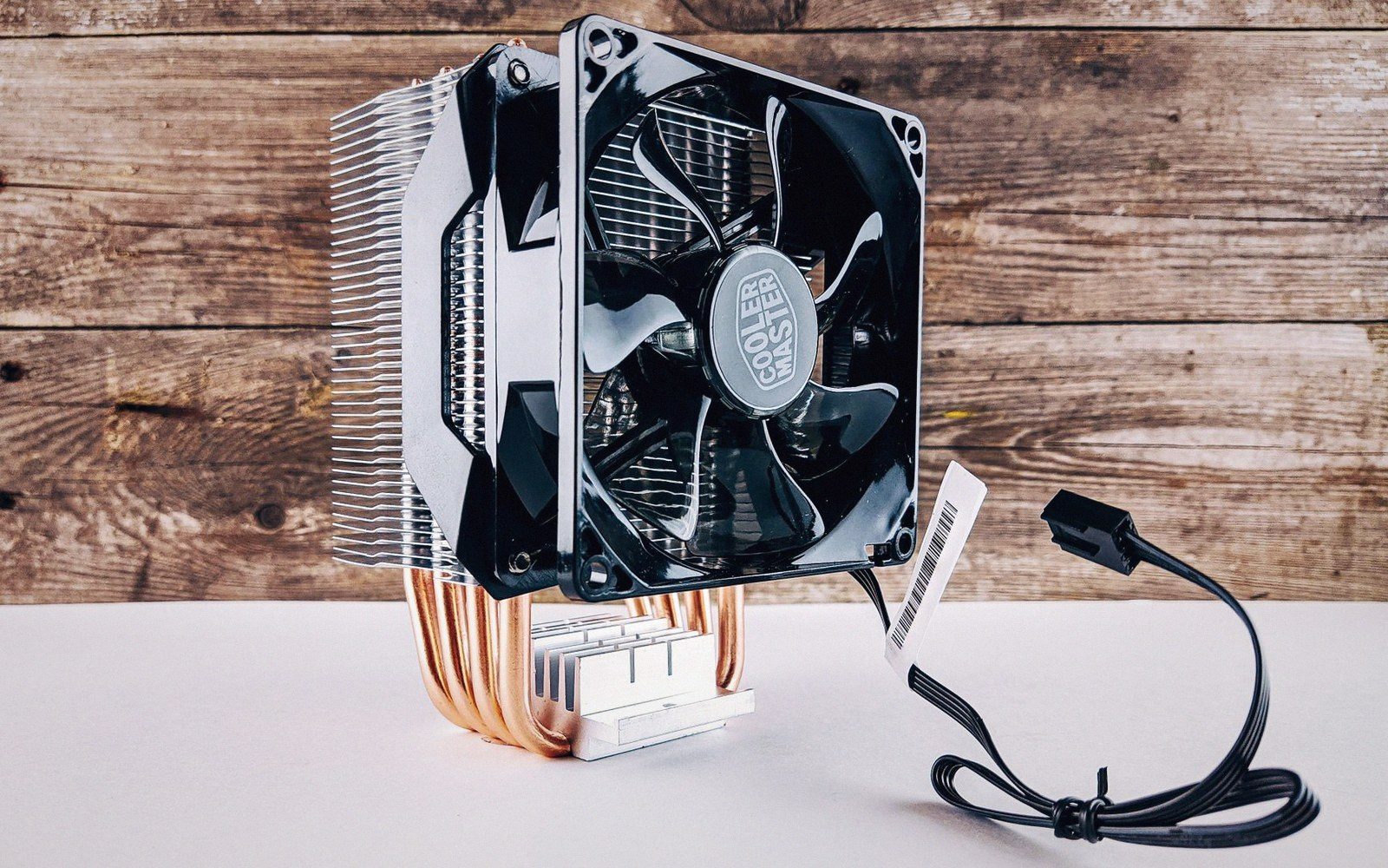 Cooler Master CPU cooler with copper heat pipes, fan, and coiled power cable