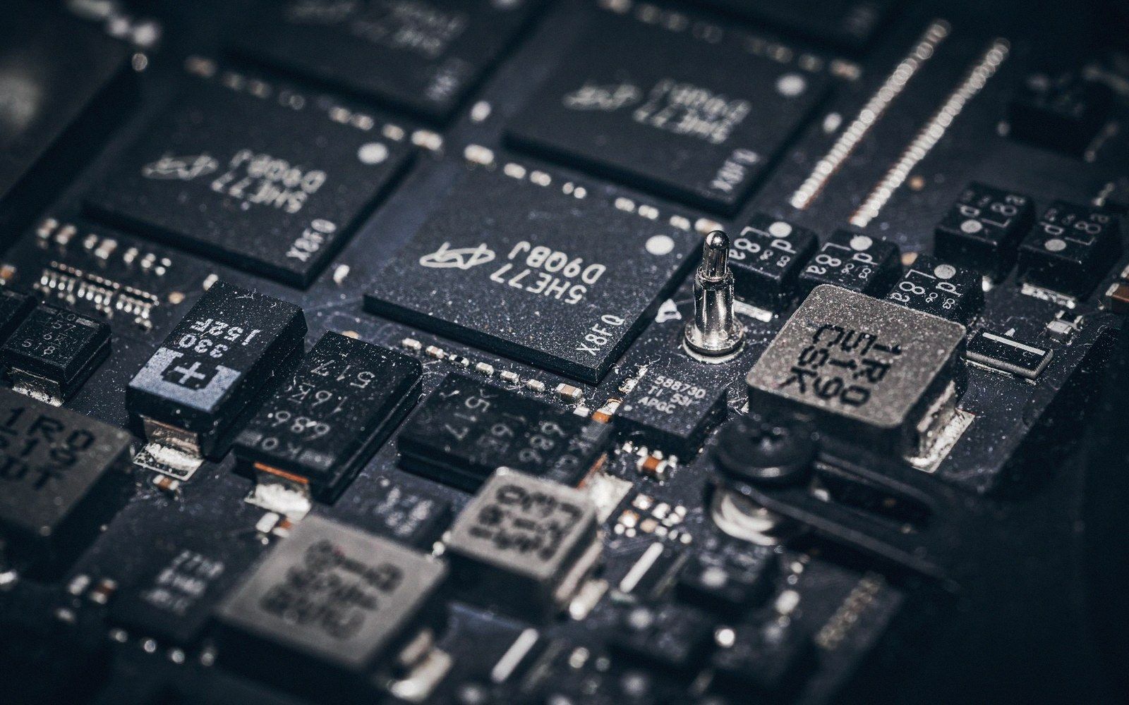 Close-up of a circuit board showing densely packed microchips and surface-mounted components