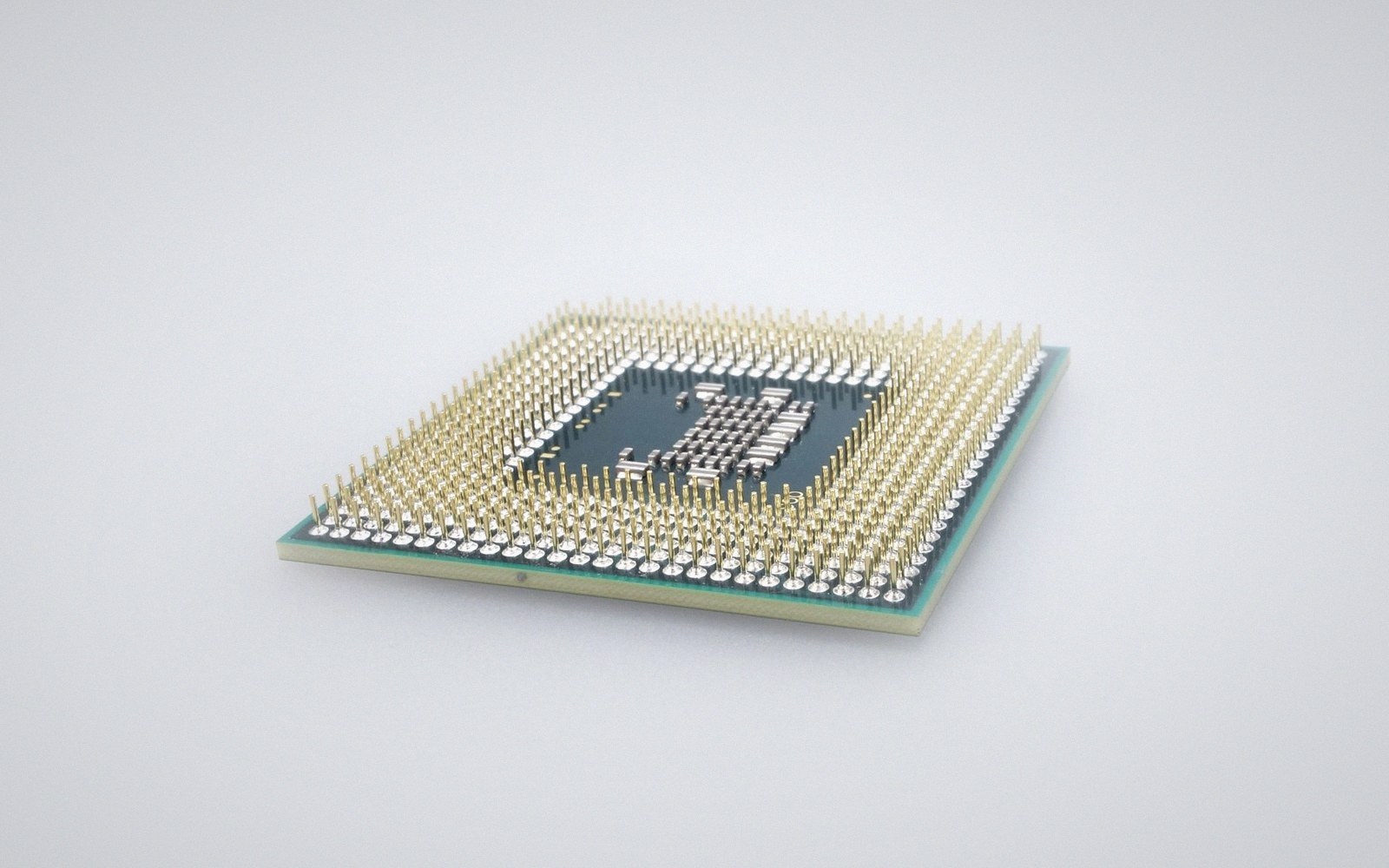 A bare processor die and socket pins, macro